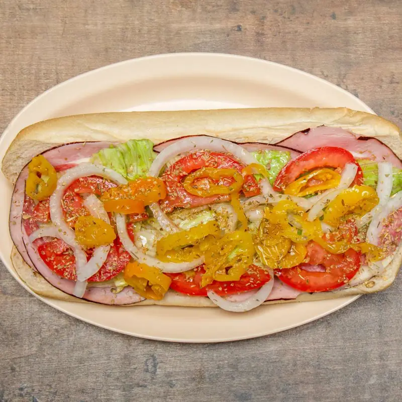 Italian sub with ham, salami, lettuce, tomato, onions and banana peppers